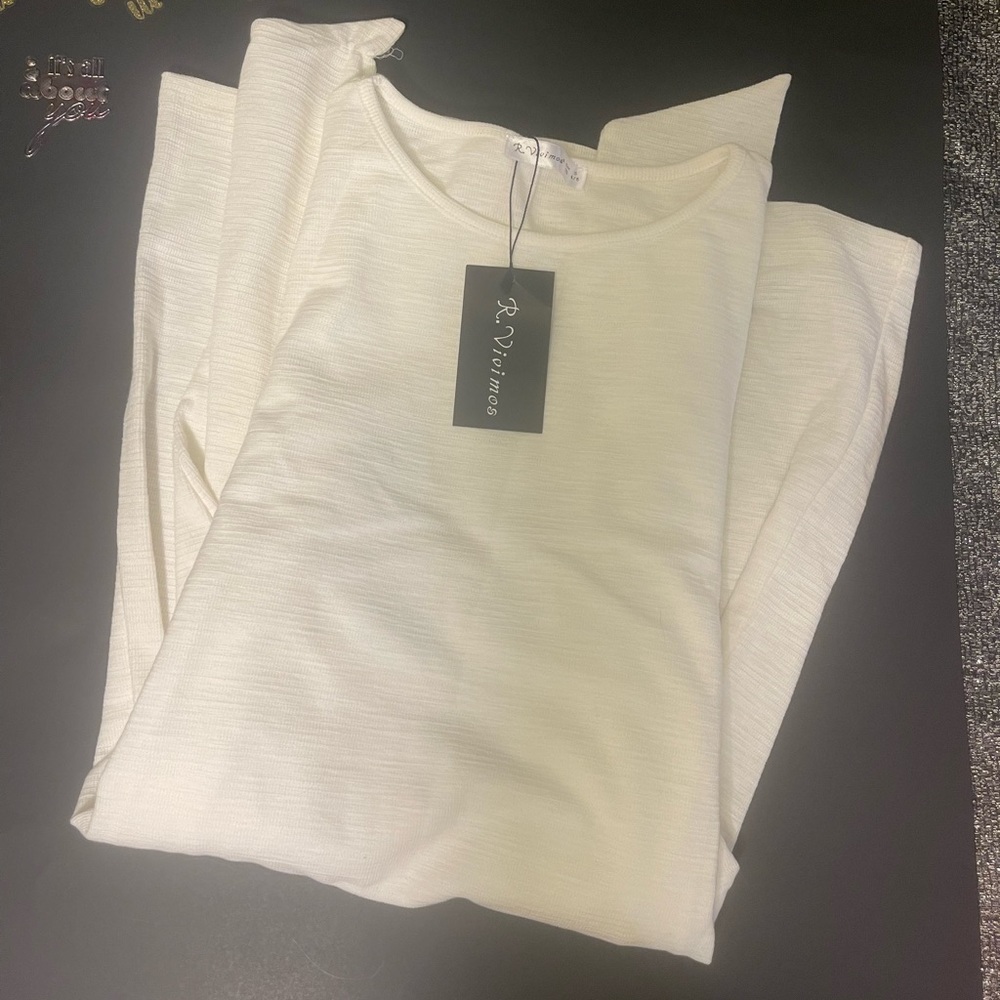 White longsleeved sweater dress with tie waist.